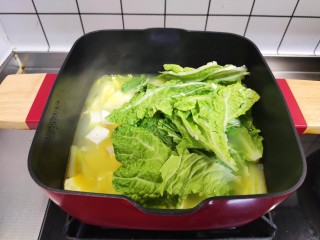 14、白菜豆腐汤,加入白菜叶，盖上锅盖再煮5分钟。
