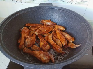 9、红烧鸭翅,将酱料裹满鸭翅，翻炒均匀。