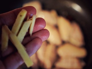 4、承味雪盐焦糖可乐鸡翅,放入鸡翅，放入姜丝。倒入半瓶经典可乐。