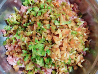 3、千张包肉,将柿子椒切成丁，放入肉馅中。