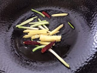 7、金牌葱姜巧烹蛏,随后，火开大，油温升至7成热，重新再放入葱白段、姜和干辣椒。