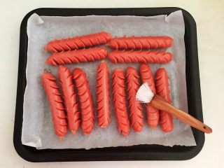 11、黑椒烤肠,在每个烤肠上均匀的刷一层大豆色拉油