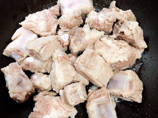 10、玉米烧排骨,放入排骨炒香。