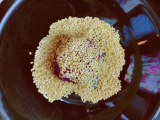 12、紫薯芝麻饼,放入芝麻里 压扁 同时反正面沾满芝麻 