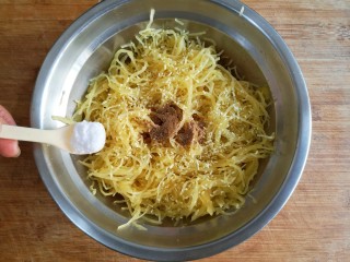 9、酥炸鱼翅南瓜丸子,在鱼翅南瓜中加入适量的盐，鸡精和少量的十三香粉搅拌均匀。