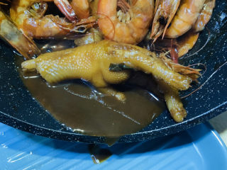 19、明虾鸡爪煲,打开锅盖，翻搅，大火煮制浓汁，起锅；