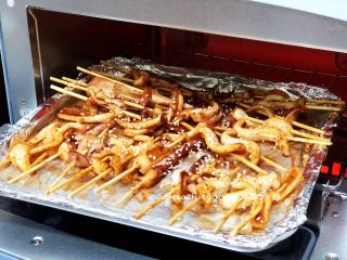 8、烤鱿鱼,倒掉汤汁洒上白芝麻，再次送进烤箱，烤熟即可