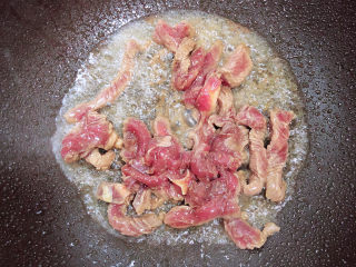 9、莴笋炒牛肉,锅中倒入油，加热至五成热，放入牛柳翻炒均匀。