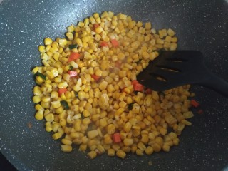 4、咸蛋黄糯米烧麦,加入玉米粒和胡萝卜丁，香菇丁翻炒至断生；