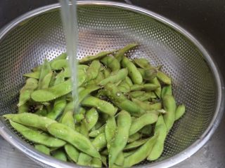 3、蒜泥毛豆节,进行冲洗，这一步主要是把毛豆表皮上的绒毛去除一些，这样不会沾到皮肤上发痒