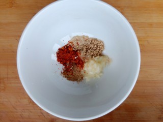 11、手撕鸡胸肉,碗中放入蒜泥，五香粉，白胡椒粉，辣椒粉，熟白芝麻