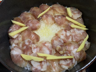 2、腊味煲仔饭,米饭略煮干后铺上香肠、姜丝焖2分钟