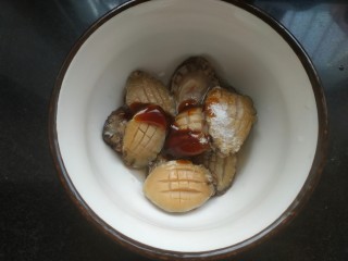 5、鲍鱼捞饭,加入一勺料酒,适量蚝油,适量盐