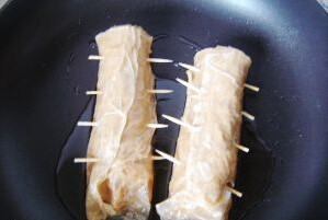 8、素烧鹅,油锅，放入腐皮卷条，小火煎到两面金黄，加入少量酱汁