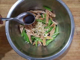 10、腐竹拌嫩芹,将焯好的芹菜和腐竹放进容器，放入蒜末，加一丢丢味极鲜酱油和香醋。
