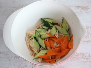 6、夏日清新小凉菜-凉拌腐竹,将腐竹、黄瓜、胡萝卜放入一个大碗内。