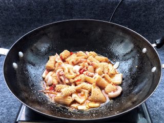 15、酱爆鱿鱼花,添加一勺豆瓣酱一起同炒,翻炒一下子鱿鱼就要卷起来了,