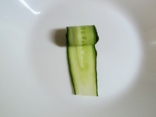 6、凉拌黄瓜卷,取一片 从一端卷起来 形成黄瓜小卷