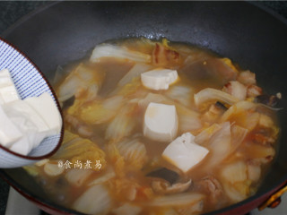 11、大杂烩一品煲,倒入豆腐，用锅铲轻轻翻动均匀，让豆腐能吸到汤汁