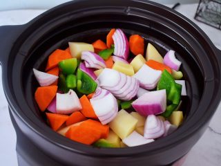 6、三汁焖锅,锅中倒入适量的食用油烧热，放入土豆、胡萝卜、洋葱、青椒