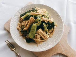 13、凉拌腐竹黄瓜,翻拌均匀装盘即可。