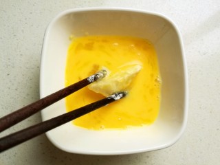 9、脆皮杏鲍菇,拖上一层打散的蛋液。