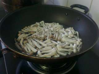 3、双菇炒肉,锅中添水烧开，倒入双菇焯烫1分钟，盛出备用；