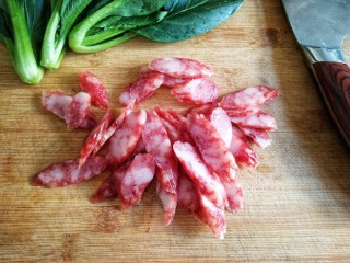 2、腊味煲仔饭,腊肠切斜刀片，这样腊肠的油汁可以渗透到饭里。