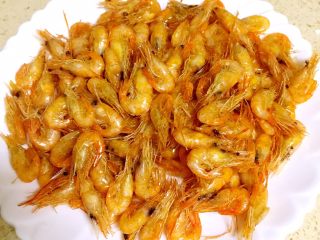 4、油爆小河虾,锅里油再次烧热至200度左右，下入小河虾复炸，使虾肉与虾壳脱开，用漏勺捞出备用。