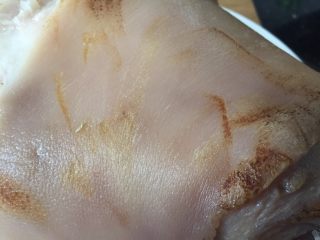 8、夏日凉菜—白切猪肘,捞出沥干，如果肉皮上有部分小杂毛，你可以放在煤气灶上用火快速烧过一遍