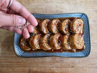 12、糖醋东北肉签子,将糖醋汁浇在肉签子上，撒适量白芝麻提香。