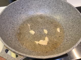 4、腊肠炒豆芽,冷锅热油，放入蒜爆香