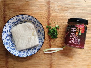 1、小葱拌豆腐,食材如图，所示示意。杏鲍菇牛肉酱是家里拌饭酱的一种，也可用其他喜欢的辣椒酱代替。