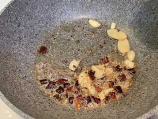 6、土豆烧鸡,冷锅热油，加入蒜片，姜片，干辣椒，花椒翻炒均匀