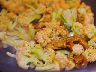 14、干锅花菜,放入花菜翻炒均匀。