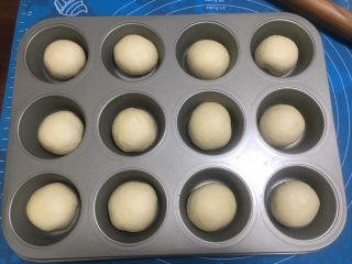 6、一口汉堡（汤种）,一发至2倍大后，将面团排气、分成12等分，这个配方面团总重量约为400克，一个面团约33克。这个模具是12连麦芬模，每个圆洞底部直径5cm，顶部直径7cm