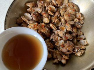 8、辣炒花蛤,沿着锅边倒入料酒