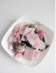 10、水煮鱼,将鱼骨和鱼头斩块待用
