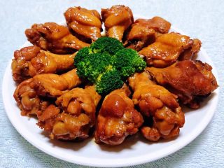 10、红烧鸡翅根,诱人的鸡翅根摆入盘中剩余的汤汁淋在上面中间用西兰花做装饰