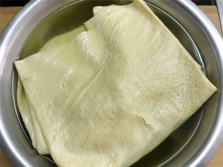 3、豆腐皮包肉,豆腐皮用温水浸泡一下让其变软后清洗干净。
