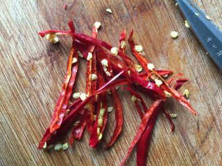 2、水煮肉片,干红辣椒用水浸泡软后擦干水分用剪刀剪成丝；