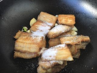 9、红烧带鱼,撒上2勺白糖。