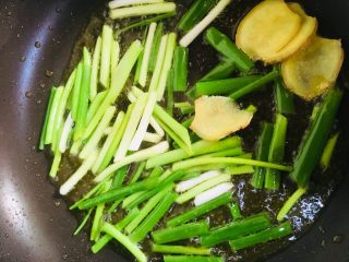 13、葱油鸡腿,放入葱段和姜片中小火炒出葱油