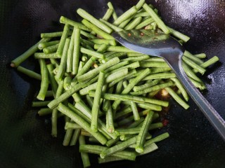 8、干煸豆角,放入豆角，翻炒。