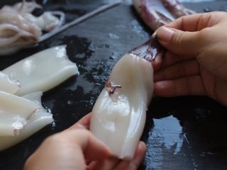 3、酱爆鲜鱿,将鱿鱼清洗干净，去除内脏，剥去外面的膜。