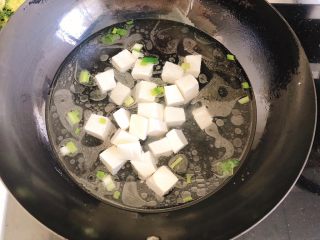 8、豆腐花哈汤,放入豆腐块，盖上锅盖。