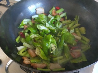 6、新文美食  麻辣椒香爆炒西芹,放入西芹，螺丝椒翻炒均匀。