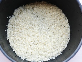 2、红烧豆腐盖饭,首先用巧釜脱糖电饭煲煮一锅香喷喷的大米饭。大米洗净放入锅中。