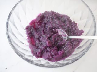 5、奶香紫薯饼,倒入容器中,用勺子把紫薯搅拌一下成泥状