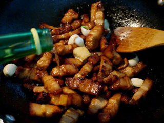 5、红烧肉炖鹌鹑蛋,随后将八角、大蒜、姜块倒入锅中，继续煸炒片刻后倒入少许白酒，让白酒充分挥发，带走肉腥味（没有白酒可用料酒替代）；